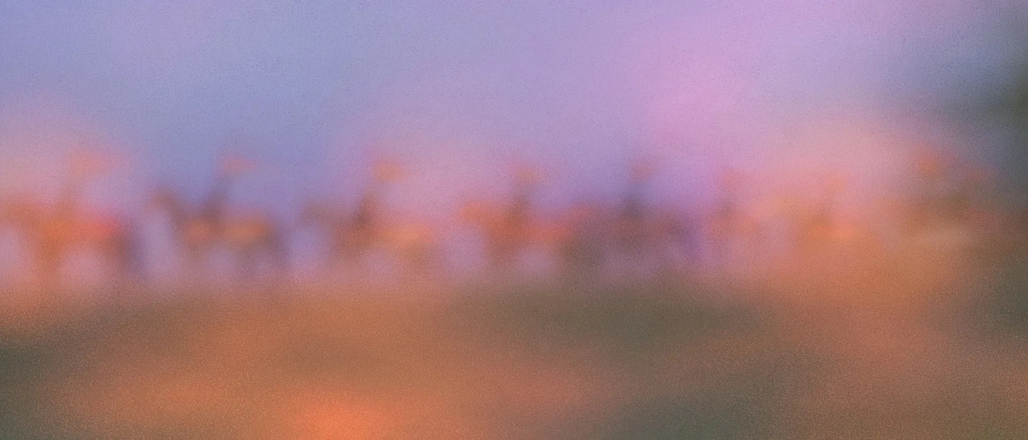 A line of knights on horseback with banners, riding along a ridge at blue hour, soft with haze.